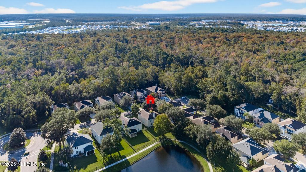 612 Spruce Creek Road St. Johns, FL 32259 - Photo 46 of 50 an aerial view of a houses with a lush green hillside
