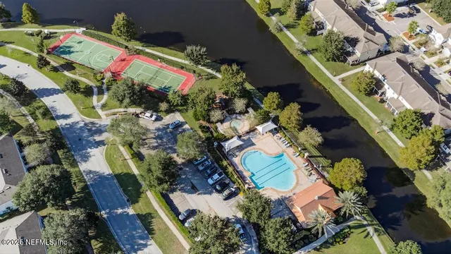 an aerial view of a house with a yard