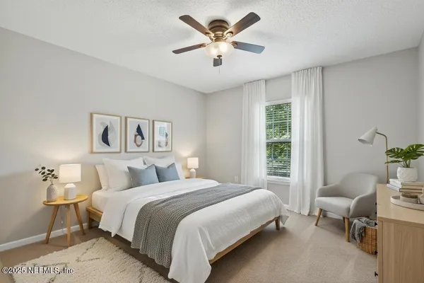 a bedroom with a bed and a chandelier