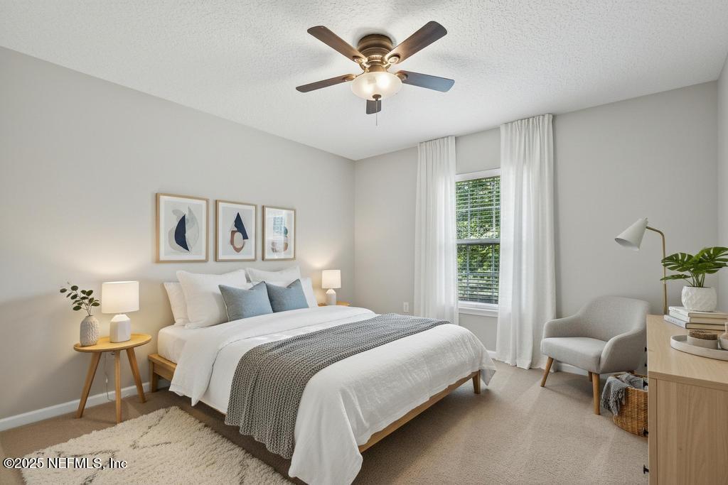 612 Spruce Creek Road St. Johns, FL 32259 - Photo 7 of 50 a bedroom with a bed and a chandelier