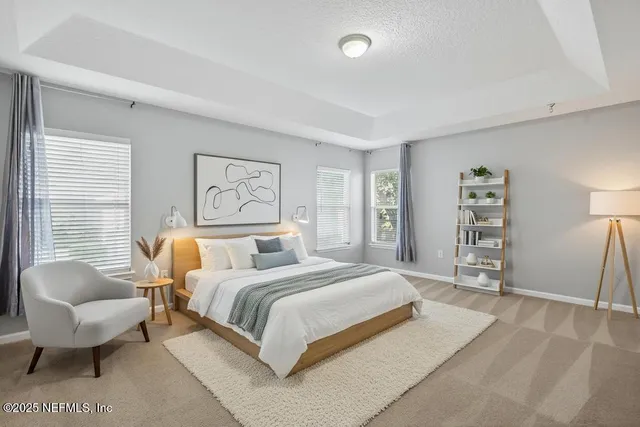 a spacious bedroom with a bed a couch and a window