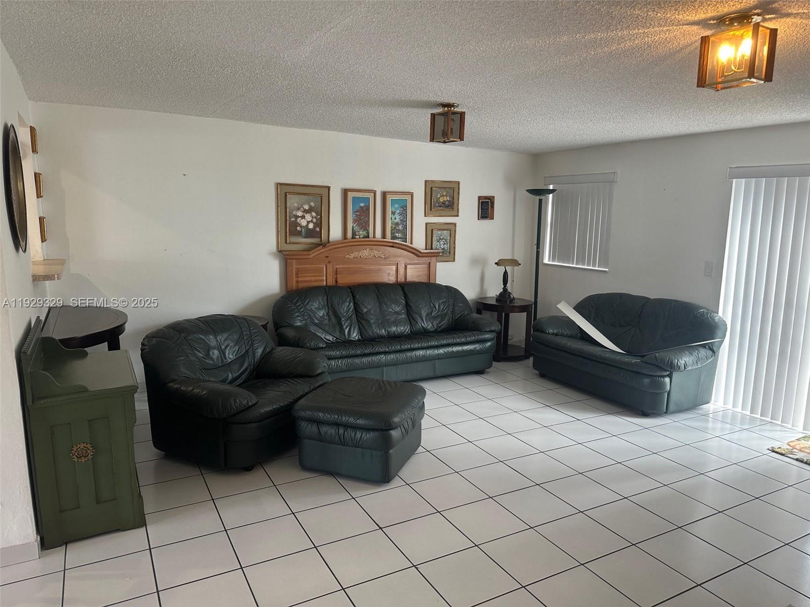 8326 Southwest 10th Terrace Miami, FL 33144 - Photo 5 of 10 a living room with furniture and a flat screen tv
