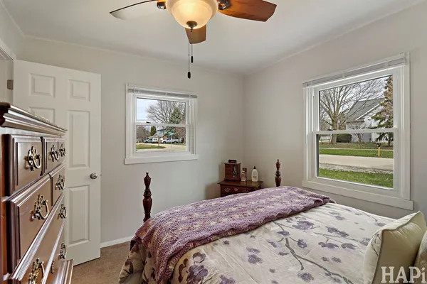 a bedroom with a bed and a painting on the wall