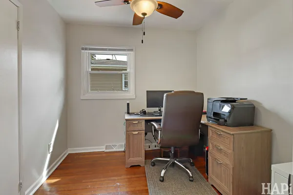 a view of workspace with wooden floor windows