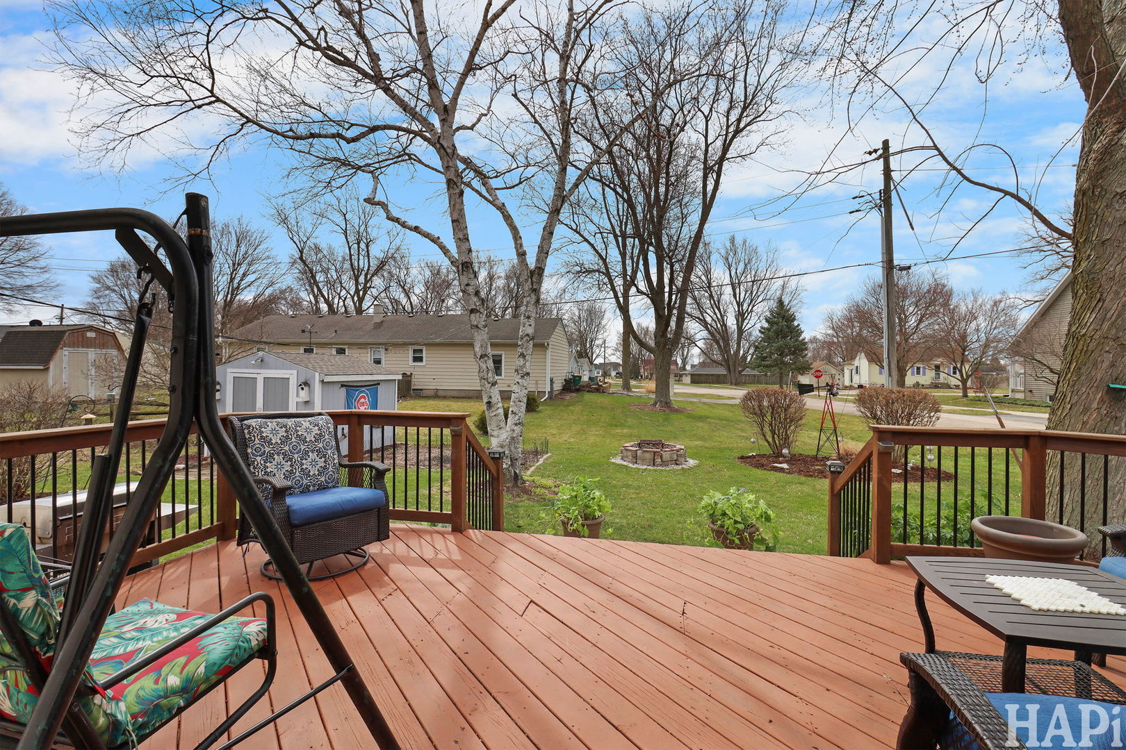804 Elm Street Maple Park, IL 60151 - Photo 25 of 31 a view of a deck with chairs and iron fence with large trees