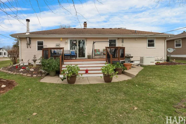 a view of a house with backyard sitting area and garden