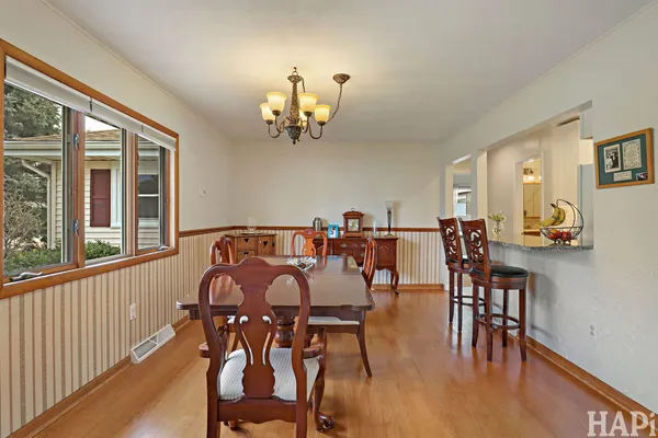 a view of a dining room with furniture window and wooden floor