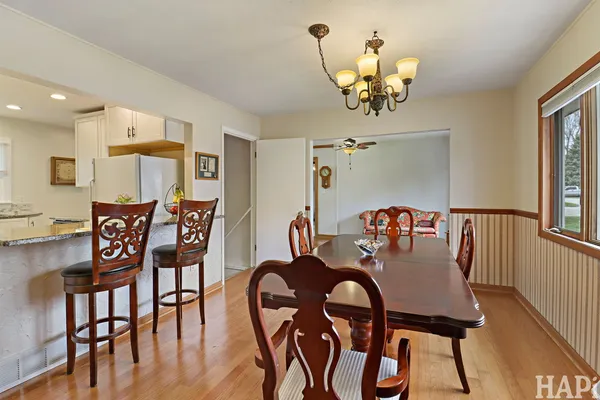 a view of a dining room with furniture and chandelier