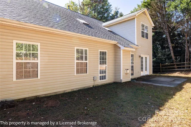 a view of a house with a yard and garage