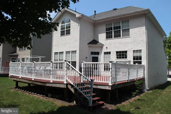 a view of a house with a wooden deck
