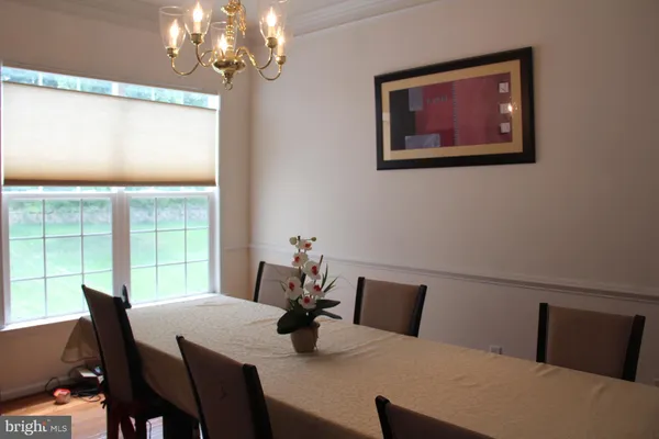 a view of a dining room with furniture and chandelier