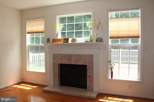 a living room with a fireplace and a window