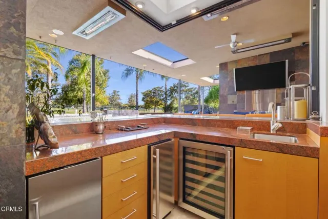 a kitchen with kitchen island granite countertop a stove and white cabinets
