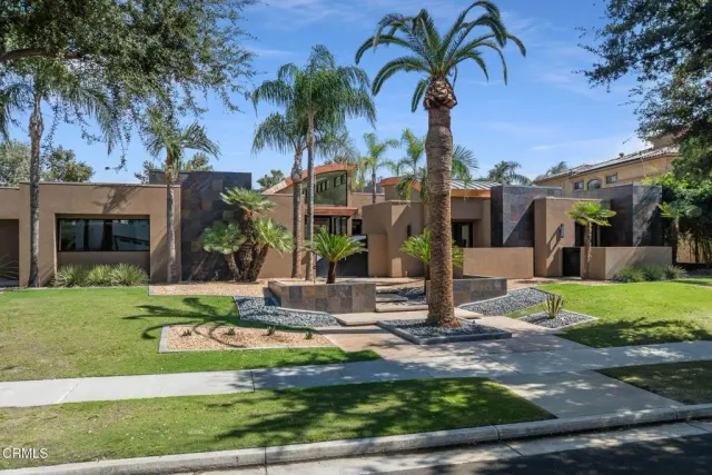 a front view of a house with garden and patio