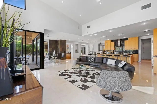 a spacious bedroom with a bed and lamp