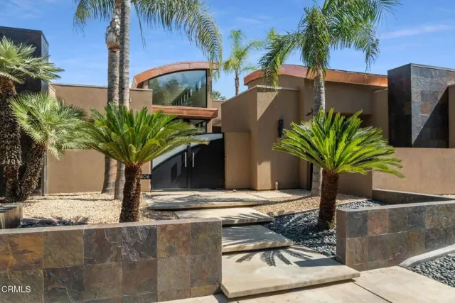 a living room with couch and large windows