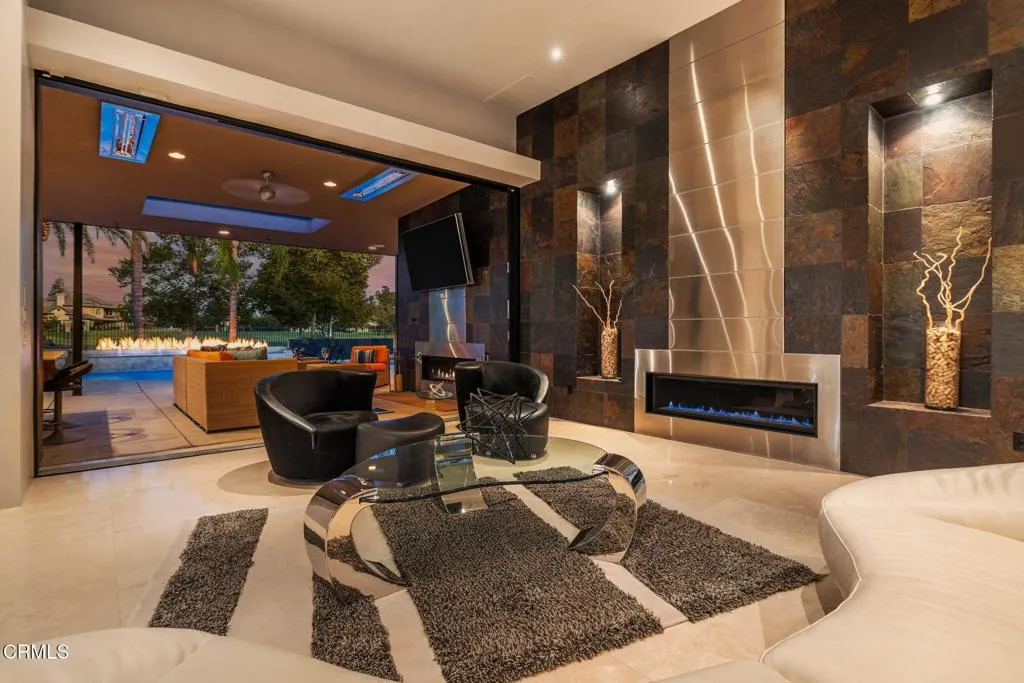 2406 Windermere Street Bakersfield, CA 93311 - Photo 69 of 75 a living room with patio furniture and a fireplace