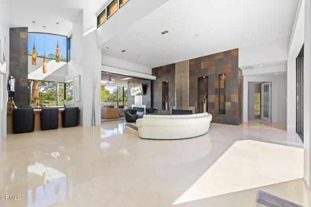 a kitchen with a sink and a large mirror