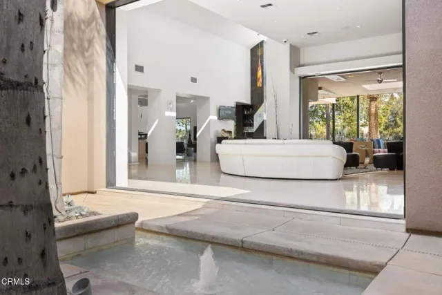 a view of a dining room with furniture and chandelier