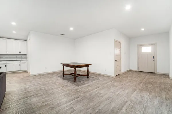 a view of a room with wooden floor and furniture