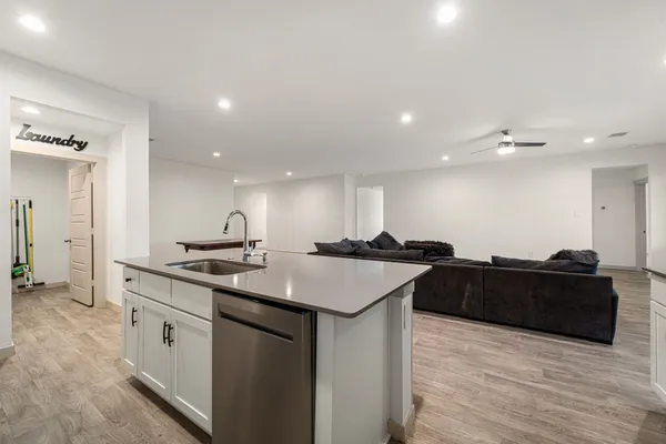 a kitchen with stainless steel appliances granite countertop a sink and a refrigerator