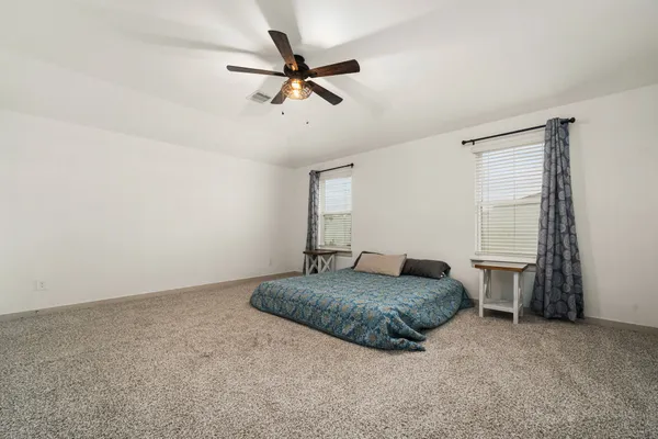 a living room with a bed furniture and a window
