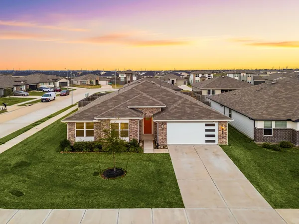 aerial view of a house with a yard