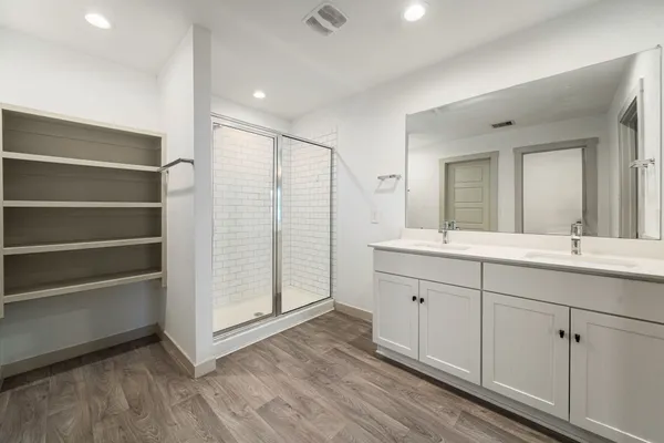a spacious bathroom with a double vanity sink and mirror
