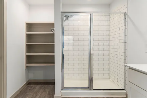 a bathroom with a glass shower door