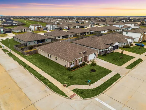 an aerial view of a residential houses with city view