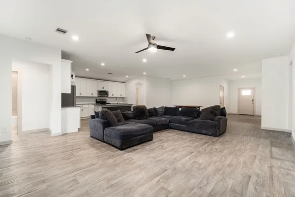a living room with furniture and kitchen view