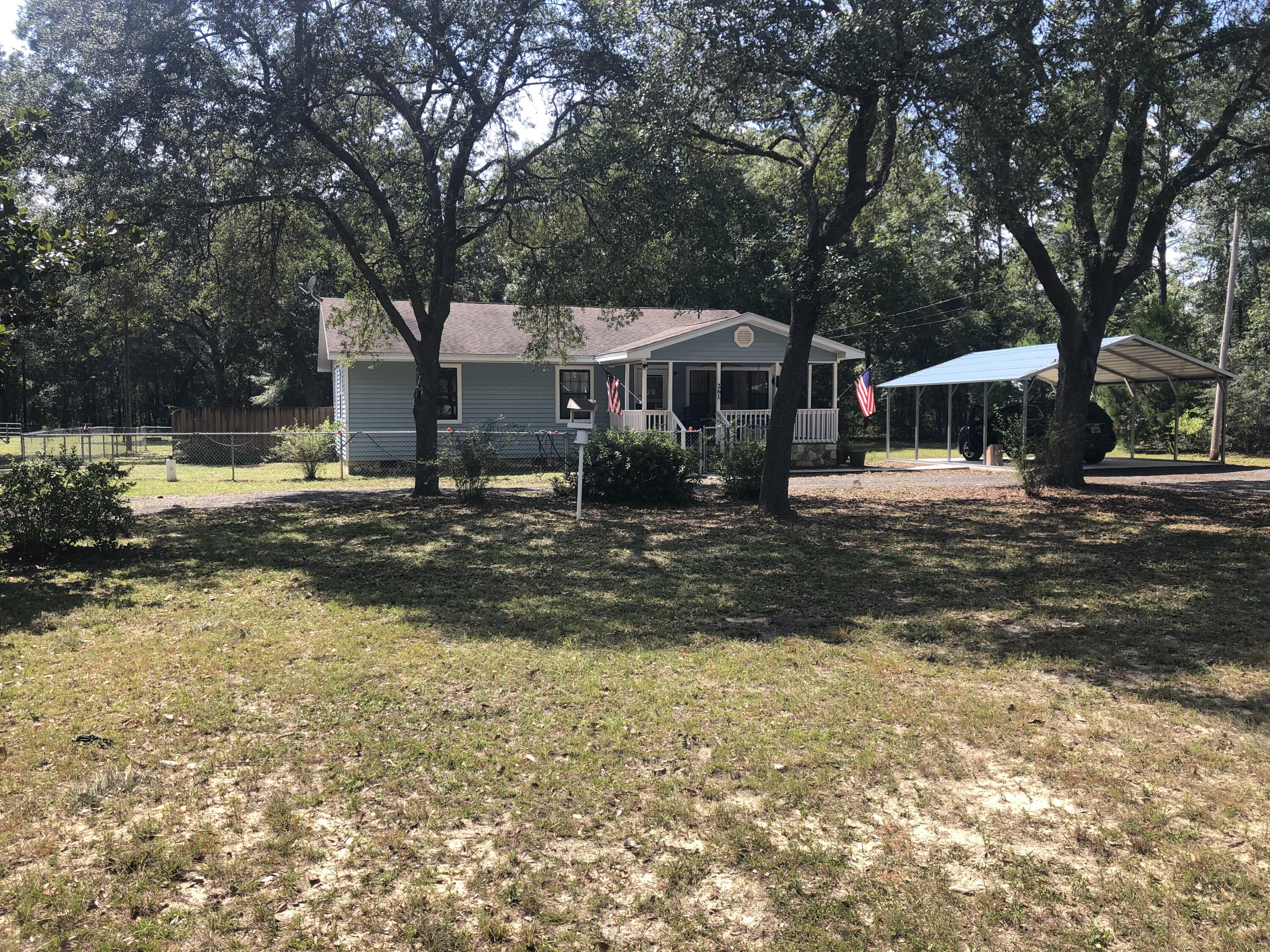 261 Roberts Road DeFuniak Springs, FL 32433 - Photo 1 of 18 a front view of a house with a yard