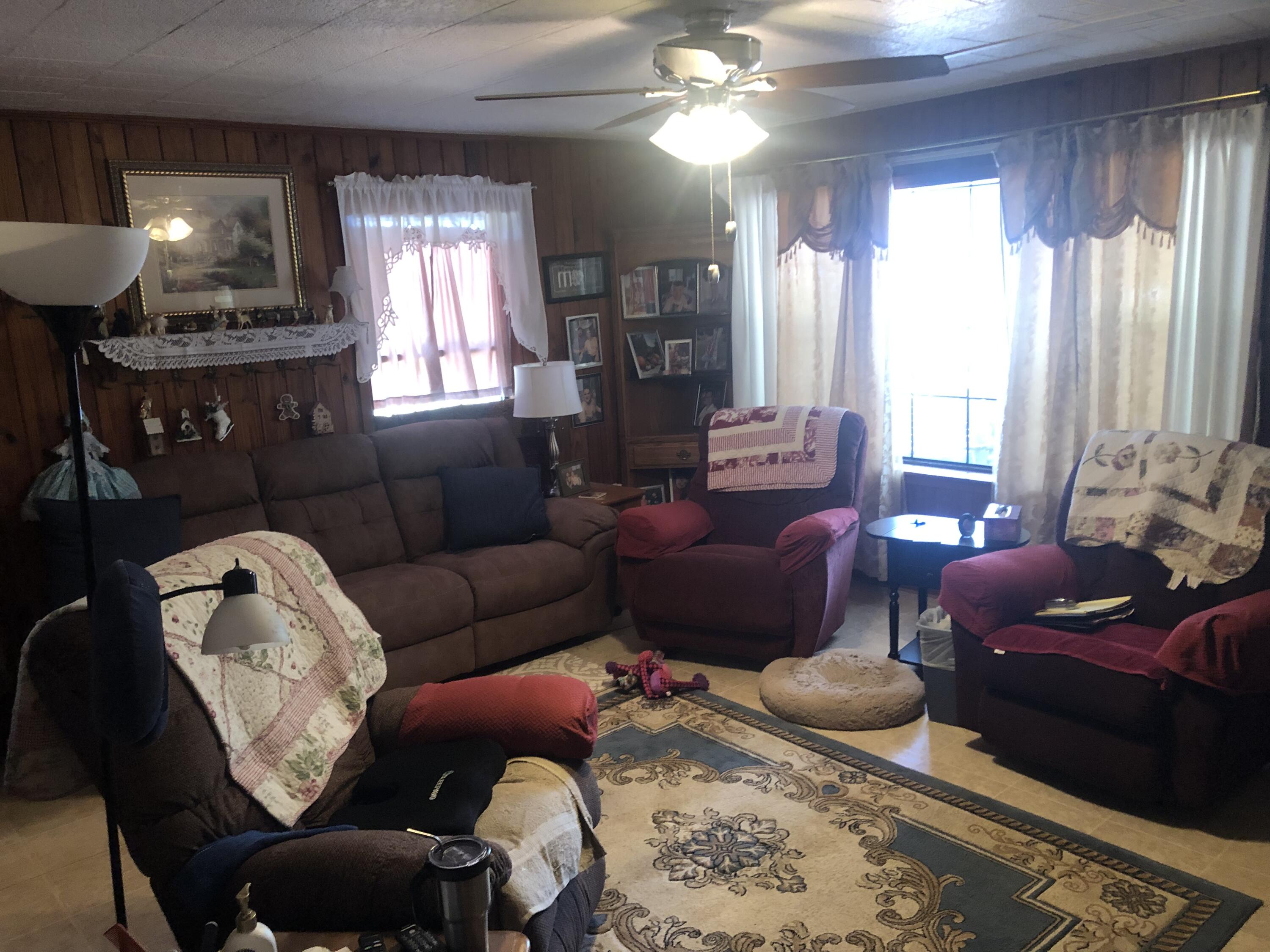 261 Roberts Road DeFuniak Springs, FL 32433 - Photo 10 of 18 a living room with furniture a lamp and a chandelier