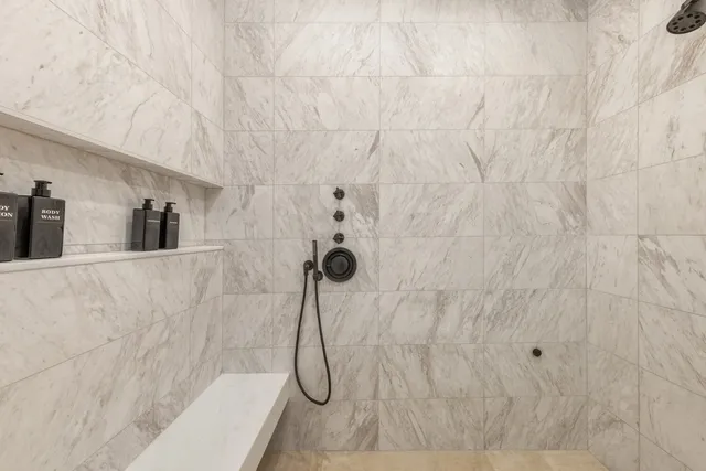 a spacious bedroom with a bed and wooden floor