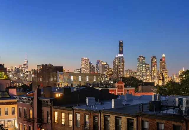 a view of a room with wooden floor and lounge chairs