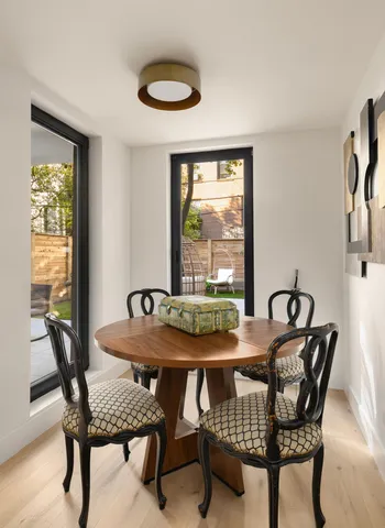 a living room filled with furniture and a floor to ceiling window
