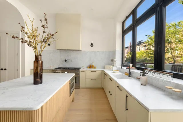a kitchen with a sink stove and cabinets