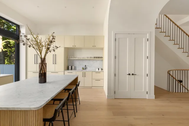 a kitchen with granite countertop white cabinets and white appliances