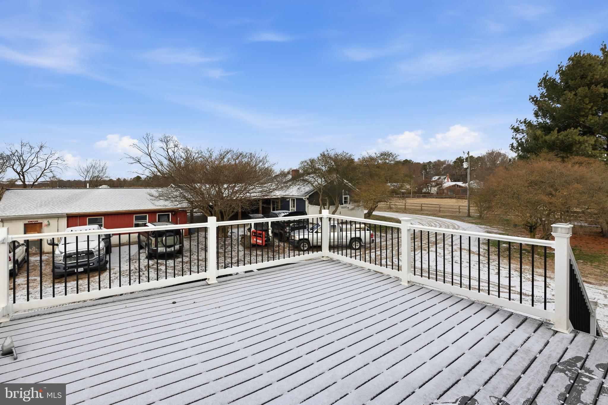 20915 Dover Bridge Road Preston, MD 21655 - Photo 43 of 60 a view of a balcony with wooden floor and fence