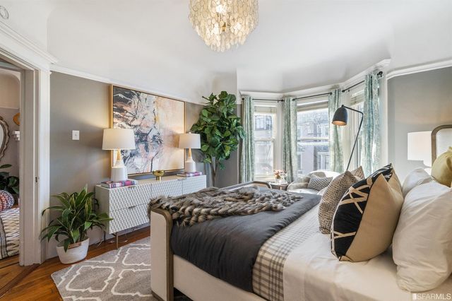 a bedroom with a bed and a potted plant