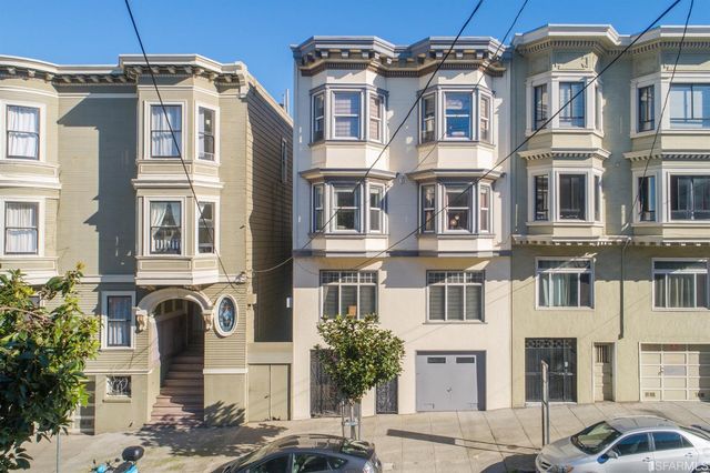 a front view of a residential apartment building with a yard