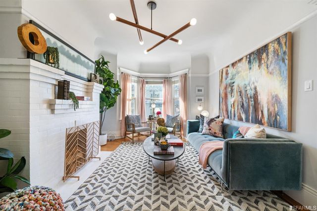 a living room with furniture and a painting on the wall
