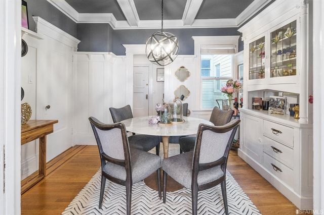 a view of a dining room with furniture and chandelier