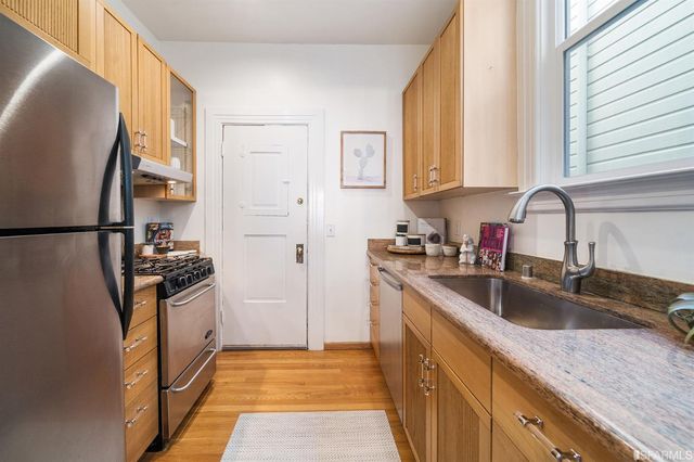 a kitchen with a sink stove and refrigerator