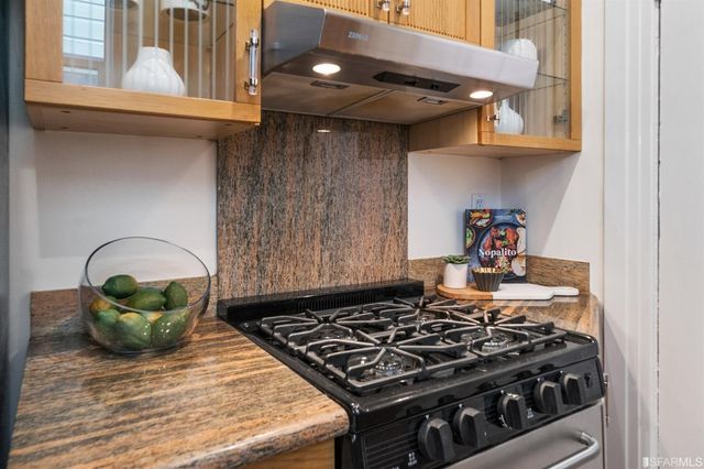 a stove top oven sitting inside of a kitchen
