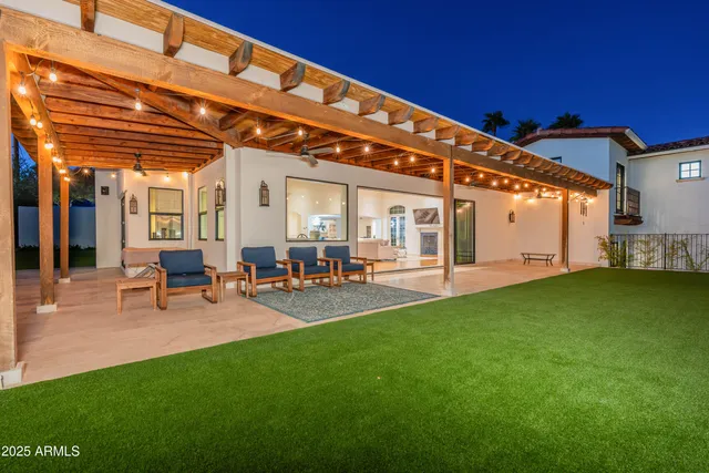 a view of a backyard with sitting area