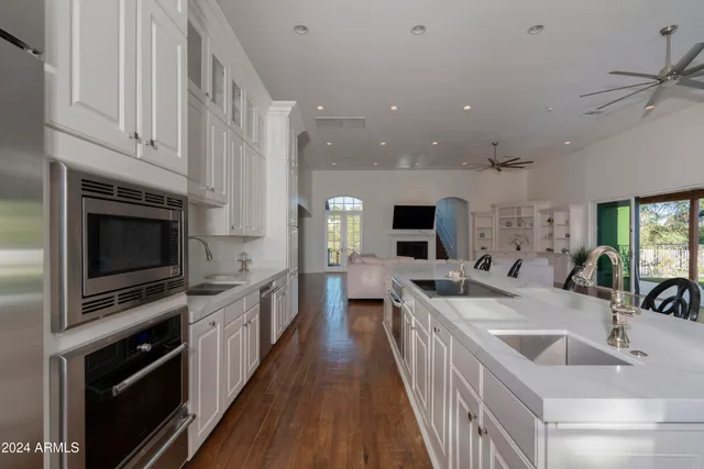 a bedroom with a large bed and a chandelier