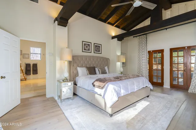 a bedroom with a bed and a painting on the wall