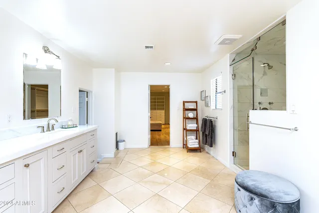a bathroom with a sink vanity tub and a mirror