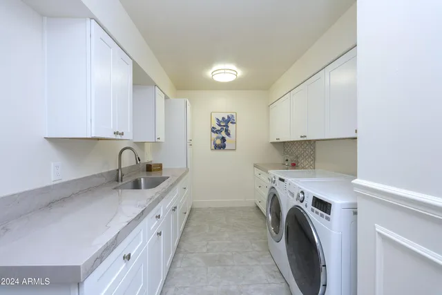 a bathroom with a granite countertop sink a toilet and a mirror